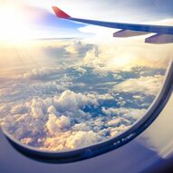 Фотообои Вид из иллюминатора самолета на облака
